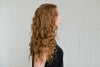 Woman with Auburn Tidal Wave Hair Extesions